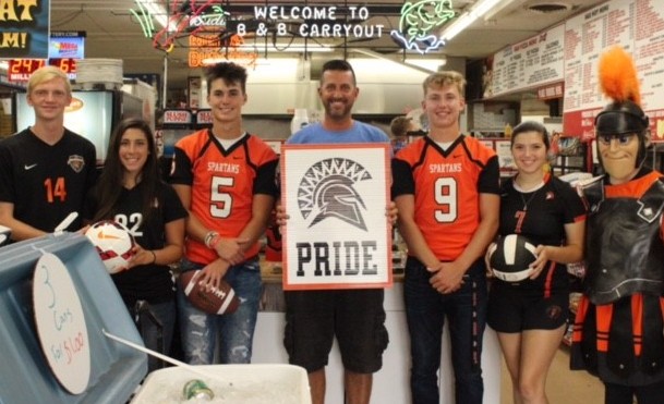 people wearing jerseys and holding sign